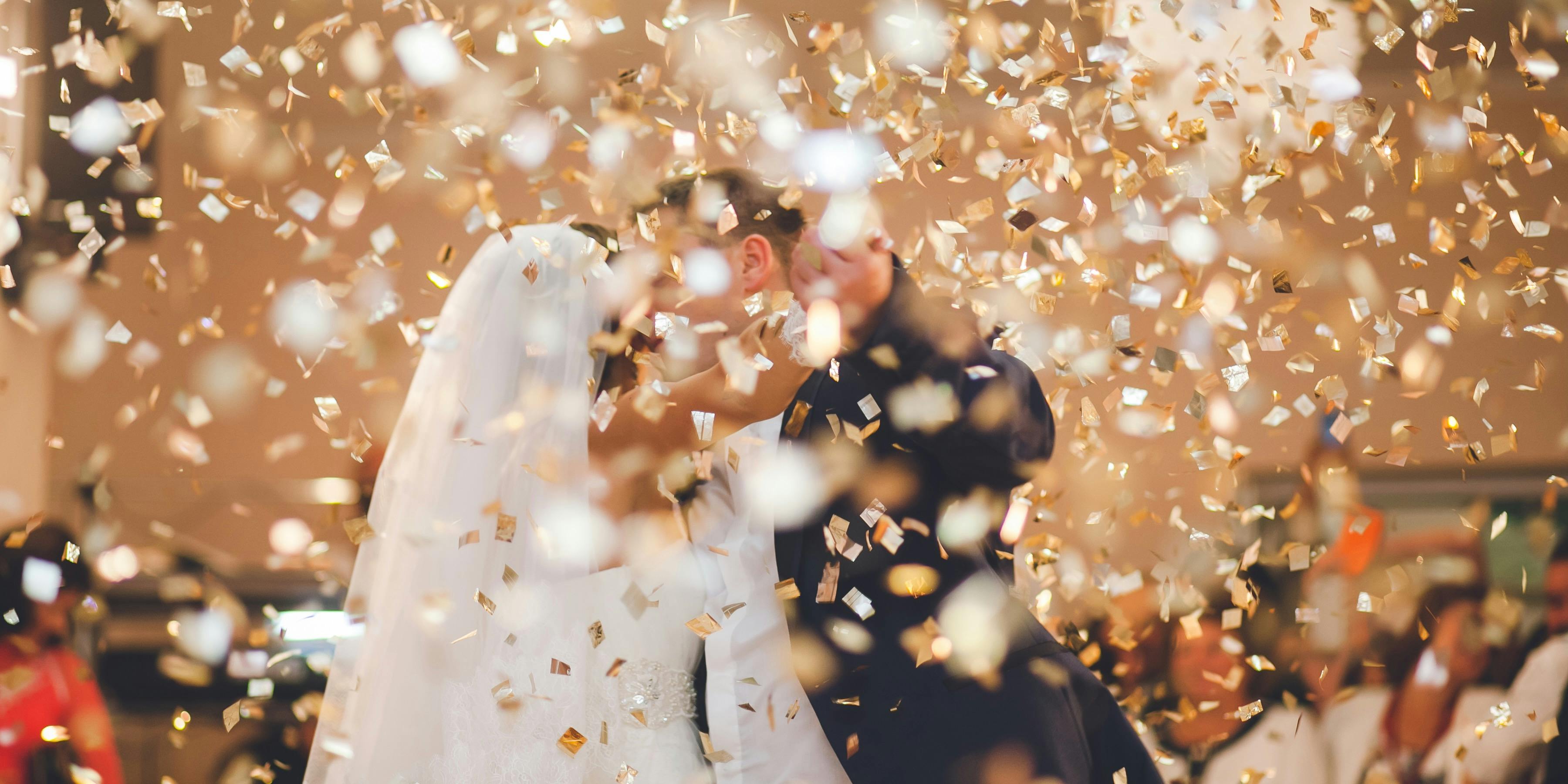 newly married couple having first dance in confetti